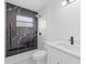 Stylish bathroom featuring a dark tiled shower, modern vanity, and neutral finishes at 4803 Sierra Madre Dr, Tampa, FL 33634