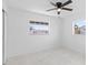 Bedroom with two windows and closet. Ceiling fan and white walls at 4803 Sierra Madre Dr, Tampa, FL 33634