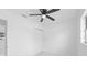 A bedroom featuring a ceiling fan, closet, and bright window, with white walls at 4803 Sierra Madre Dr, Tampa, FL 33634