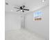 Bright bedroom featuring white walls, ceiling fan, and a window at 4803 Sierra Madre Dr, Tampa, FL 33634