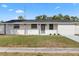 Attractive one-story home with green lawn, freshly painted exterior, and inviting walkway at 4803 Sierra Madre Dr, Tampa, FL 33634