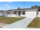 Inviting single-story home with a freshly painted exterior and well-manicured front yard at 4803 Sierra Madre Dr, Tampa, FL 33634