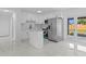 Modern kitchen with white cabinets, stainless steel appliances, and easy access to the backyard at 4803 Sierra Madre Dr, Tampa, FL 33634
