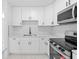 Bright kitchen features white cabinets, stainless steel appliances, and a modern backsplash at 4803 Sierra Madre Dr, Tampa, FL 33634