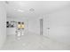 Bright, open-concept living space with marble tile flooring leading into the modern kitchen at 4803 Sierra Madre Dr, Tampa, FL 33634