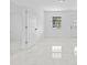 Spacious living area features marble flooring, recessed lighting, and a view of the front entrance at 4803 Sierra Madre Dr, Tampa, FL 33634
