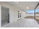Covered patio featuring white walls, tiled floor, and a doorway at 4803 Sierra Madre Dr, Tampa, FL 33634