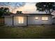 A single-story home featuring a neutral paint color, a covered patio, and double doors at 4803 Sierra Madre Dr, Tampa, FL 33634