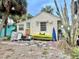 Cozy backyard with a colorful kayak, succulent garden, and outdoor seating area at 503, 509, Cottage, Land 69Th Ave, St Pete Beach, FL 33706