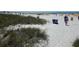 Sunny beach with white sand, blue water, and beachgoers enjoying the day at 503, 509, Cottage, Land 69Th Ave, St Pete Beach, FL 33706