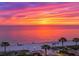 Scenic view of a beach sunset with vibrant colors and palm trees along the shore at 503, 509, Cottage, Land 69Th Ave, St Pete Beach, FL 33706