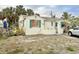 Quaint cottage-style home with shutters, a well-manicured lawn, and off-street parking at 503, 509, Cottage, Land 69Th Ave, St Pete Beach, FL 33706