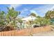 Outdoor view of a single-story home with a white exterior and fenced yard at 503, 509, Cottage, Land 69Th Ave, St Pete Beach, FL 33706