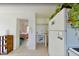 Bright kitchen leading to bedroom featuring white appliances and refrigerator at 503, 509, Cottage, Land 69Th Ave, St Pete Beach, FL 33706