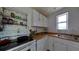 Bright kitchen featuring white cabinetry, countertop space, and modern appliances at 503, 509, Cottage, Land 69Th Ave, St Pete Beach, FL 33706