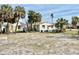 Expansive lot with sandy soil, palm trees, and plenty of space for outdoor activities at 503, 509, Cottage, Land 69Th Ave, St Pete Beach, FL 33706