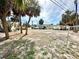 Open lot with sandy soil, palm trees, and ample space for building at 503, 509, Cottage, Land 69Th Ave, St Pete Beach, FL 33706