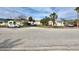 Street view of a white single story property near several commercial properties on a sunny day at 503, 509, Cottage, Land 69Th Ave, St Pete Beach, FL 33706