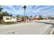 Street view of a white single story property near several commercial properties on a sunny day at 503, 509, Cottage, Land 69Th Ave, St Pete Beach, FL 33706