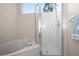 Clean bathroom featuring a glass shower, soaking tub, and neutral colors at 5117 Fairway One Dr, Valrico, FL 33596