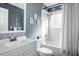Well-lit bathroom with decorative tiles, modern fixtures, and storage space at 5117 Fairway One Dr, Valrico, FL 33596