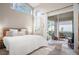 Bright bedroom featuring a large window, patio access, and comfortable furnishings at 5117 Fairway One Dr, Valrico, FL 33596