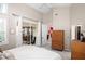 Airy bedroom featuring patio access, modern furniture, and neutral paint at 5117 Fairway One Dr, Valrico, FL 33596