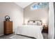Cozy bedroom with a large window, dresser, lamps, and a comfortable bed at 5117 Fairway One Dr, Valrico, FL 33596
