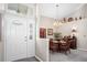 Inviting foyer featuring a chandelier, high ceilings, and views into the dining area at 5117 Fairway One Dr, Valrico, FL 33596