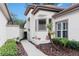 Inviting entrance with neutral colors, manicured landscape, and a walkway to the front door at 5117 Fairway One Dr, Valrico, FL 33596