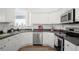 Modern kitchen with stainless steel appliances, gray countertops, and white cabinetry at 5117 Fairway One Dr, Valrico, FL 33596