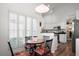 Eat-in kitchen with white cabinets, a decorative rooster, and abundant natural light at 5117 Fairway One Dr, Valrico, FL 33596