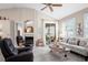 Spacious living room with a fireplace, vaulted ceilings, and sliding glass doors to the patio at 5117 Fairway One Dr, Valrico, FL 33596