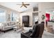 Comfortable living room featuring a sofa, two chairs, and an entertainment center at 5117 Fairway One Dr, Valrico, FL 33596