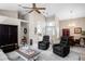 Bright living room with tall ceilings, ceiling fan, decor, and two leather chairs at 5117 Fairway One Dr, Valrico, FL 33596