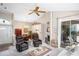 Spacious living room featuring lots of seating and natural light with views into the dining room at 5117 Fairway One Dr, Valrico, FL 33596