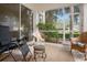 Relaxing screened-in patio with comfortable seating and views of the lush backyard at 5117 Fairway One Dr, Valrico, FL 33596