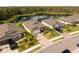 An aerial view showcases well-maintained homes with lush landscaping and a serene lake backdrop at 5511 Badini Way, Palmetto, FL 34221