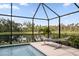 Enjoy tranquil lake views from your backyard, complete with a cozy hammock by the pool at 5511 Badini Way, Palmetto, FL 34221