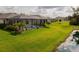 Expansive, well-maintained backyard featuring serene lake views and a screened-in pool area at 5511 Badini Way, Palmetto, FL 34221