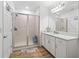 Bright bathroom featuring a glass enclosed shower with modern vanity and stylish flooring at 5511 Badini Way, Palmetto, FL 34221