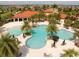 Stunning aerial view of the community pool with palm trees and a resort-style setting at 5511 Badini Way, Palmetto, FL 34221