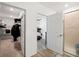 Hallway shot featuring views into a walk-in closet, bedroom, and bathroom at 5511 Badini Way, Palmetto, FL 34221