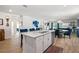 Kitchen featuring an island with white cabinets, stainless steel dishwasher, and seating at 5511 Badini Way, Palmetto, FL 34221