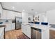 Bright kitchen featuring stainless steel appliances, white cabinets, and an island at 5511 Badini Way, Palmetto, FL 34221