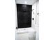 Modern bathroom with sleek black tile, glass-enclosed shower, and contemporary fixtures at 5625 Gateway Dr, Tampa, FL 33615