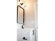 Bathroom featuring a black framed mirror, modern fixtures, and a white vanity at 5625 Gateway Dr, Tampa, FL 33615
