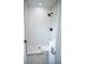 Bright bathroom with white tile, glass-enclosed shower, and contemporary fixtures at 5625 Gateway Dr, Tampa, FL 33615