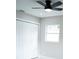 Bedroom with modern ceiling fan, neutral paint, and built-in closet at 5625 Gateway Dr, Tampa, FL 33615