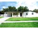 Charming single-story home featuring a well-manicured lawn and freshly painted exterior at 5625 Gateway Dr, Tampa, FL 33615